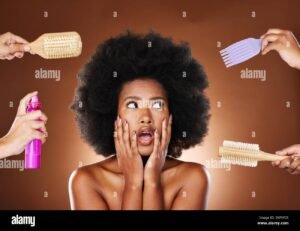 black-woman-thinking-of-hair-care-tools-for-natural-afro-and-decision-making-of-beauty-products-shocked-african-girl-with-choices-salon-brushes-and-2KF9FC6-1